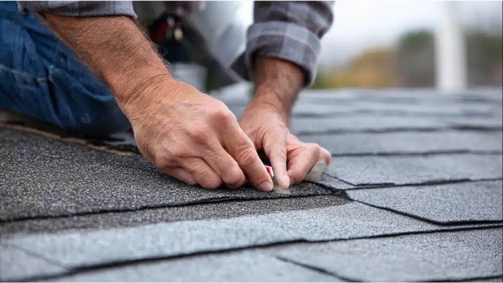 Skilled roofer using advanced equipment to repair residential roof in Howard, WI with attention to detail