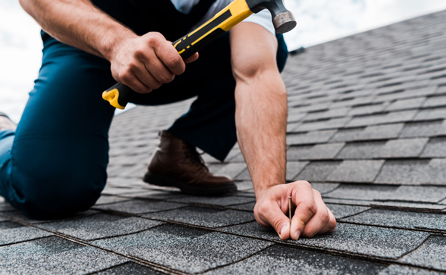 Skilled roofer using advanced equipment to repair residential roof in Howard, WI with attention to detail
