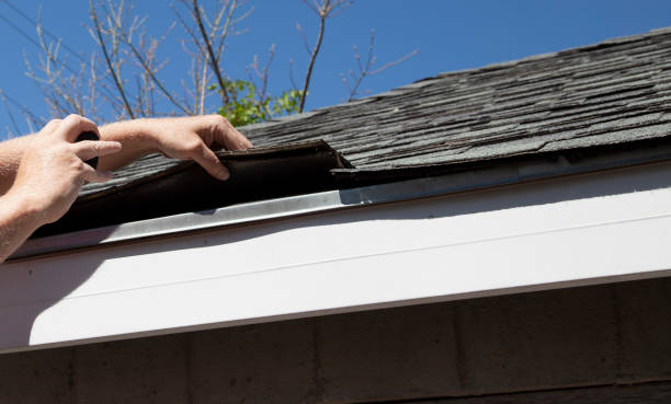 Technician performing roof repair on a steep home in Muskego, WI while checking flashing details